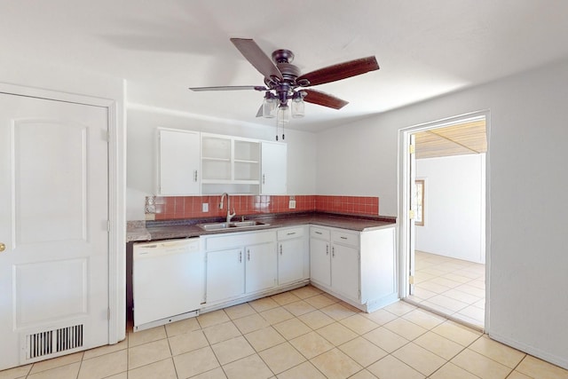 kitchen with white cabinets, white dishwasher, sink, and decorative backsplash