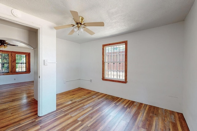 spare room featuring hardwood / wood-style flooring, a textured ceiling, and ceiling fan