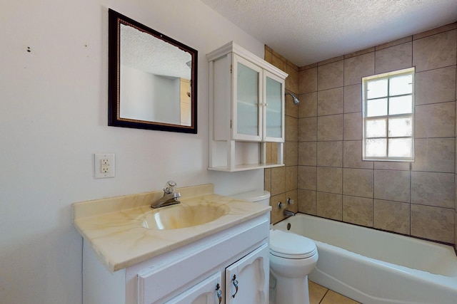 full bathroom with tiled shower / bath, vanity, toilet, and a textured ceiling