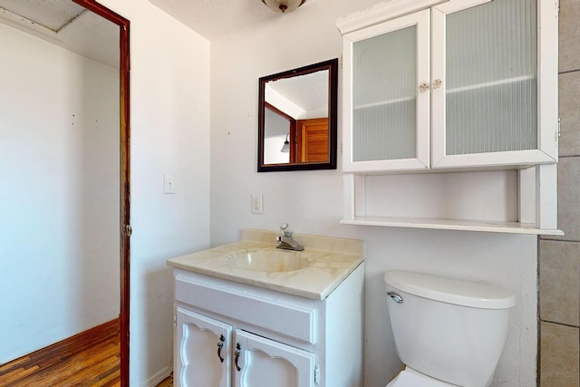 bathroom featuring hardwood / wood-style flooring, vanity, and toilet