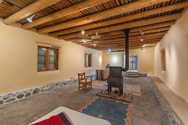 basement with wood ceiling and a wood stove