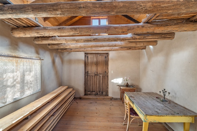 basement featuring wood ceiling and light hardwood / wood-style floors