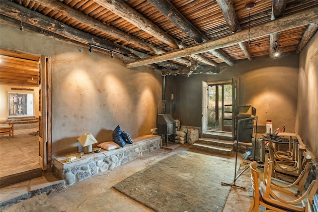 miscellaneous room featuring beam ceiling, wooden ceiling, and track lighting