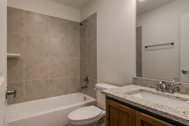 full bathroom featuring toilet, tiled shower / bath combo, and vanity