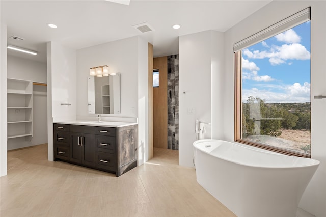 bathroom with plus walk in shower and vanity