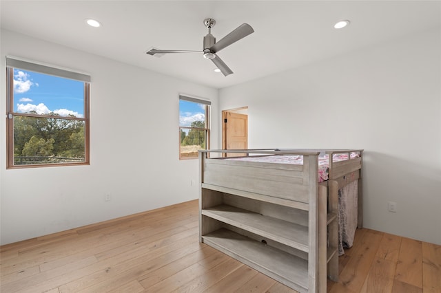 bedroom featuring multiple windows, ceiling fan, and light hardwood / wood-style floors