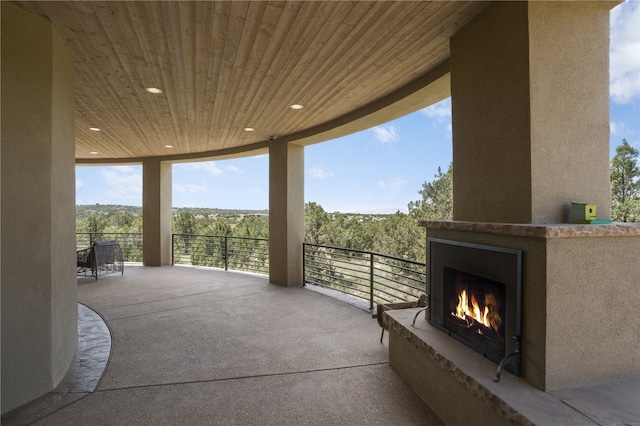 view of patio with exterior fireplace