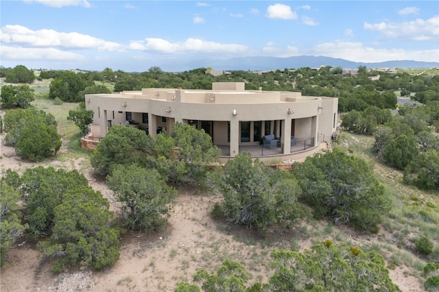 rear view of house featuring a mountain view