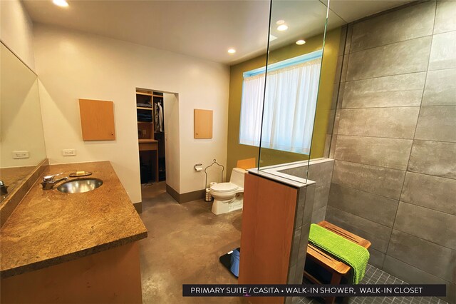 bathroom with vanity, toilet, a shower, and concrete floors