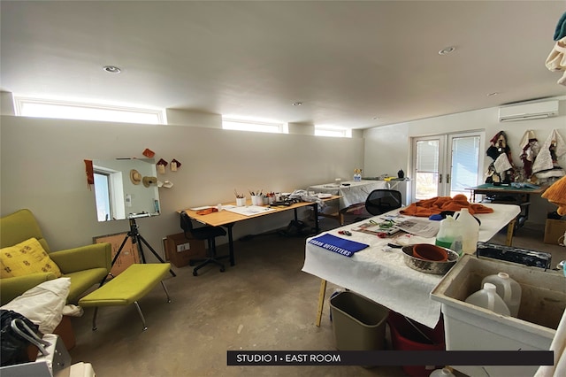 dining space with a wall mounted AC, french doors, and concrete floors