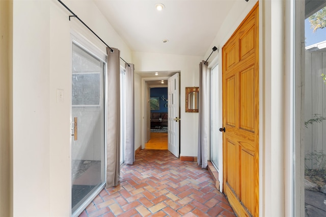 hall with lofted ceiling and a barn door