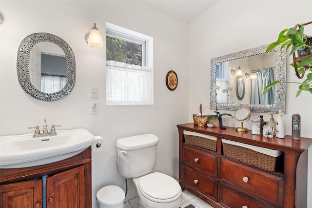 bathroom featuring vanity, toilet, and tile patterned flooring