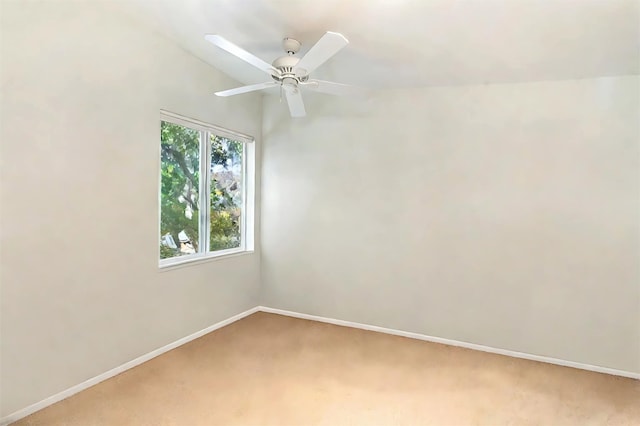 carpeted spare room with lofted ceiling and ceiling fan