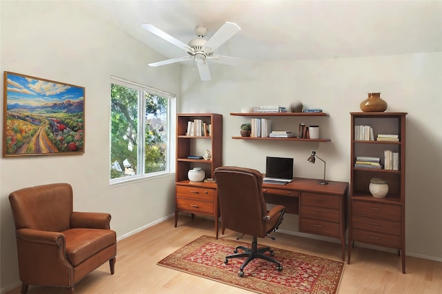 home office with vaulted ceiling, light wood-type flooring, and ceiling fan