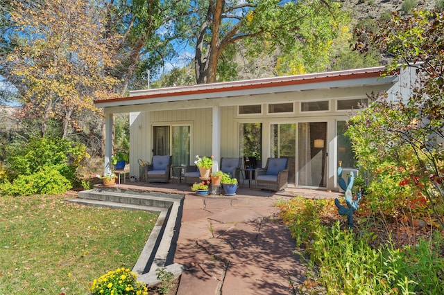 exterior space featuring a patio area and a lawn