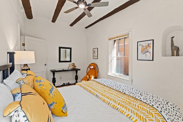 bedroom with beamed ceiling and ceiling fan