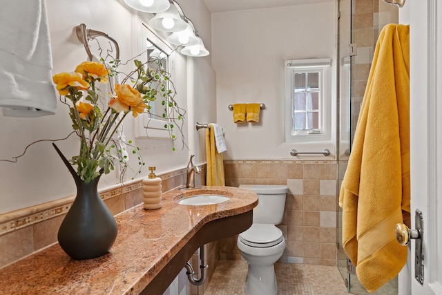 bathroom featuring vanity, tile walls, toilet, and tile patterned flooring