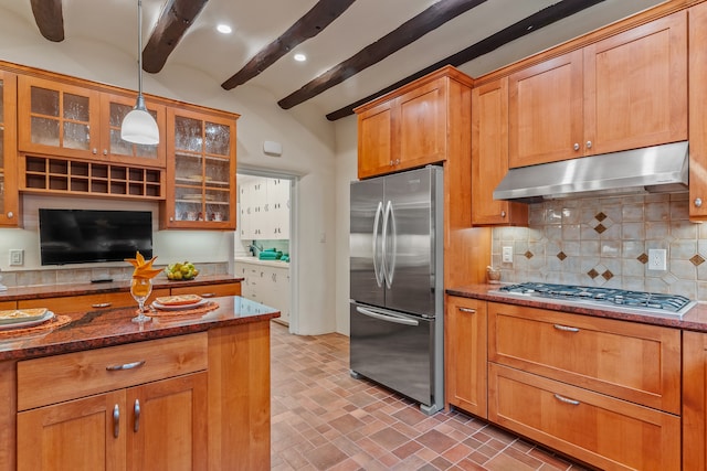 kitchen featuring tasteful backsplash, appliances with stainless steel finishes, vaulted ceiling with beams, dark stone counters, and pendant lighting