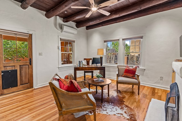 sitting room with a wall mounted AC, beamed ceiling, wooden ceiling, light hardwood / wood-style floors, and ceiling fan