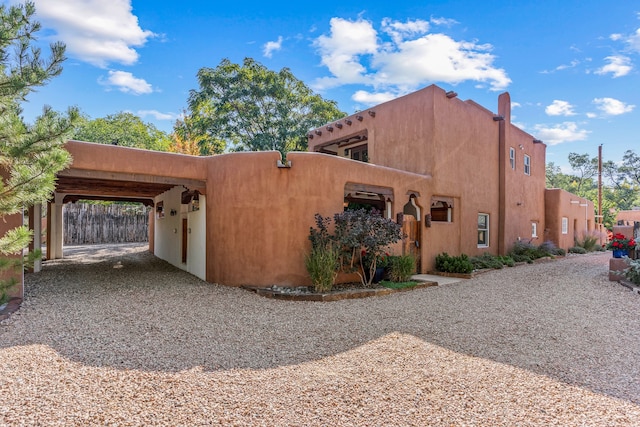 view of side of home featuring a carport