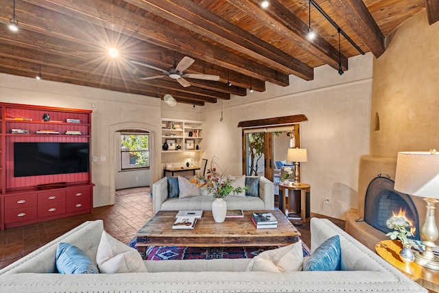 living room featuring ceiling fan, wooden ceiling, and beamed ceiling