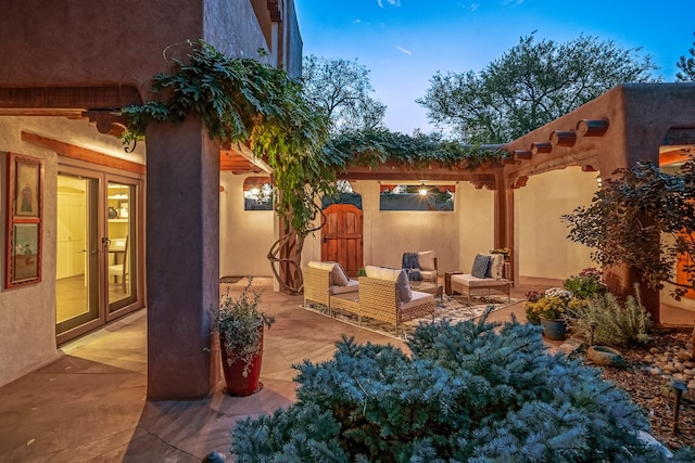 patio terrace at dusk featuring an outdoor living space