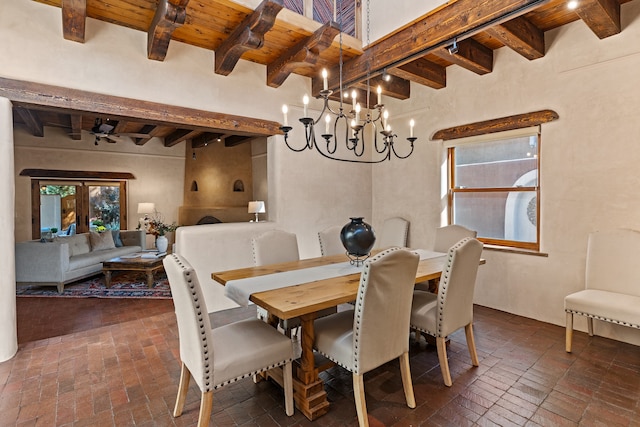 dining room featuring french doors, beam ceiling, wooden ceiling, and a chandelier