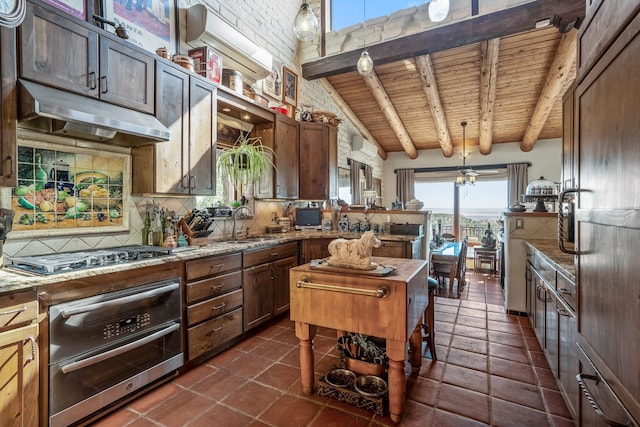 kitchen with backsplash, beam ceiling, stainless steel appliances, decorative light fixtures, and wooden ceiling