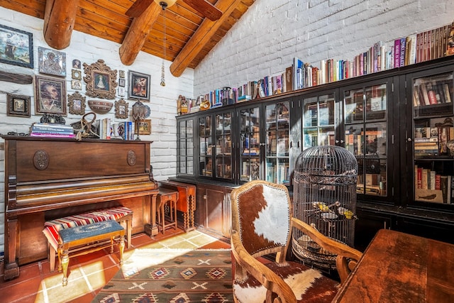 living area featuring wood ceiling, brick wall, and vaulted ceiling with beams