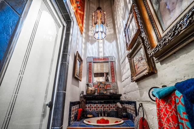 interior space featuring vanity, a towering ceiling, and walk in shower