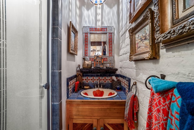 bathroom featuring vanity and a shower with shower door