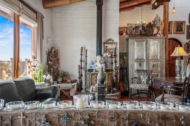 interior space featuring beam ceiling and a wood stove