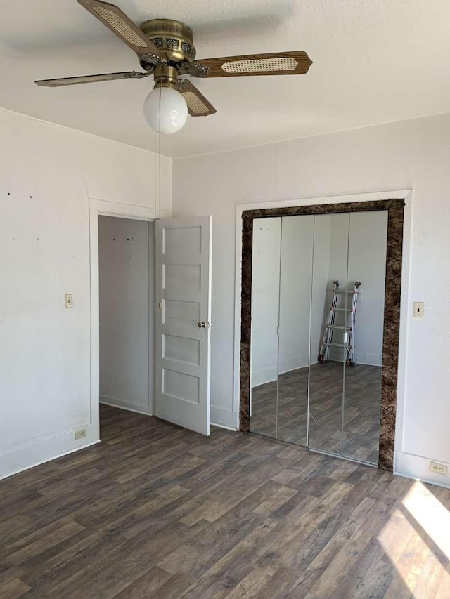 unfurnished bedroom with dark hardwood / wood-style floors and ceiling fan