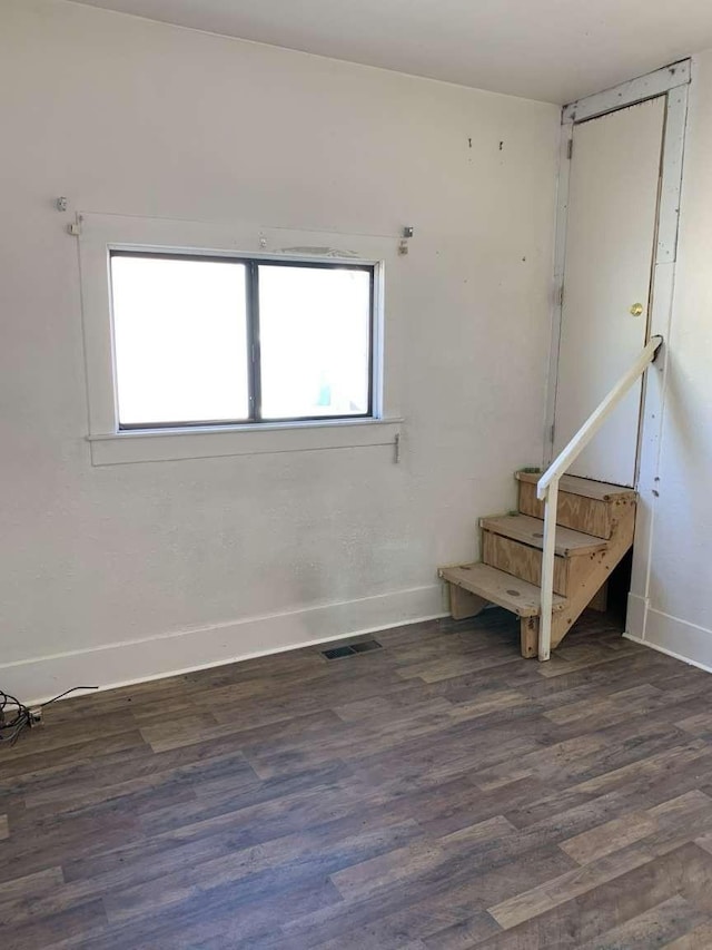 unfurnished room featuring dark hardwood / wood-style floors