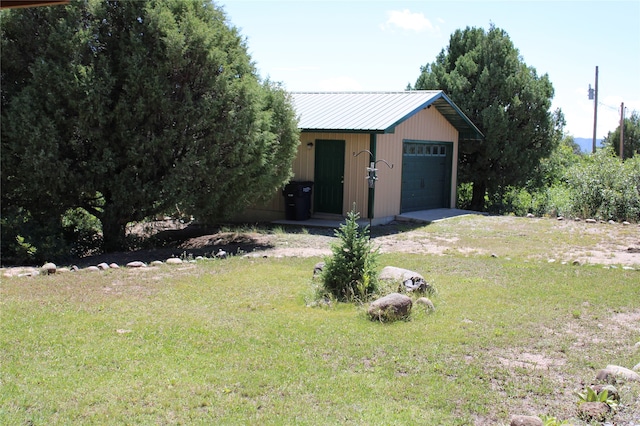 view of yard with a storage shed and a garage