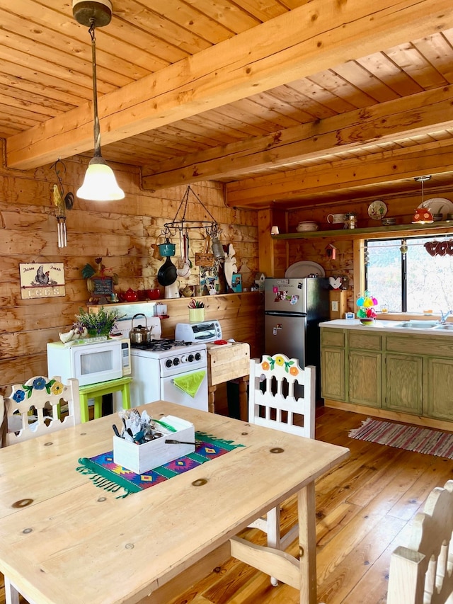 dining space with beam ceiling, wood walls, wooden ceiling, and light wood-type flooring