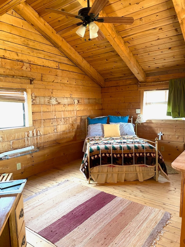 bedroom featuring light hardwood / wood-style floors, wood ceiling, wood walls, and lofted ceiling with beams