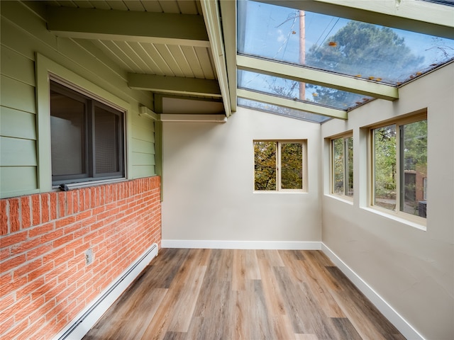 unfurnished sunroom with vaulted ceiling with beams and a baseboard radiator