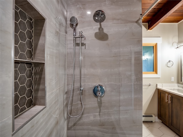 bathroom featuring vanity, a tile shower, tile patterned flooring, and a baseboard radiator