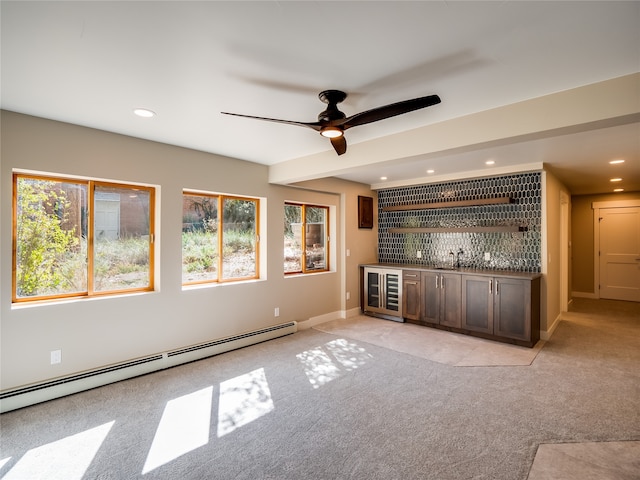 bar with dark brown cabinetry, a baseboard radiator, light colored carpet, and beverage cooler