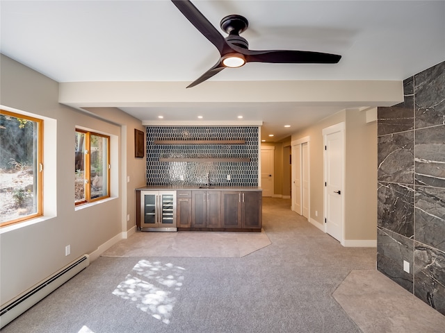 bar featuring beverage cooler, baseboard heating, tile walls, dark brown cabinetry, and sink