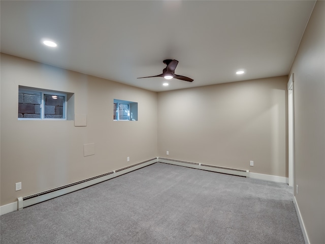 carpeted empty room featuring baseboard heating and ceiling fan