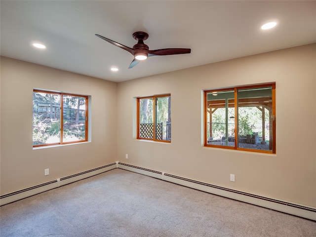 carpeted spare room featuring a baseboard radiator and ceiling fan