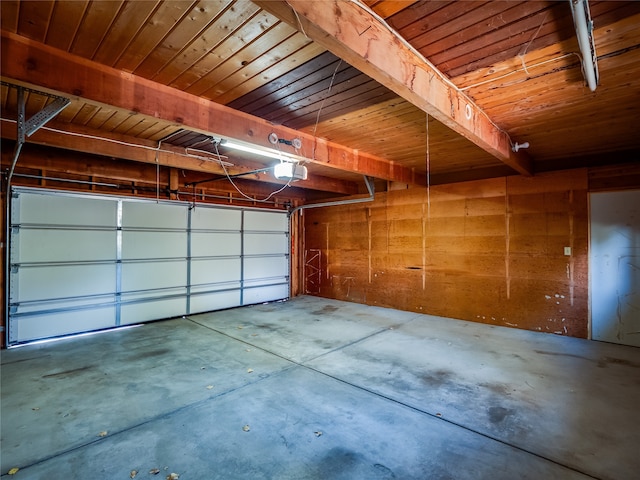 garage featuring a garage door opener and wood ceiling