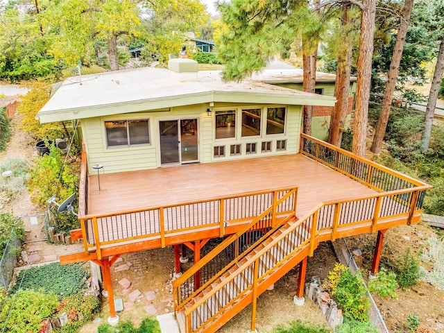 back of property featuring a wooden deck