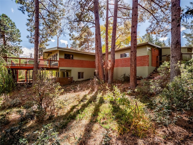 rear view of house with a wooden deck