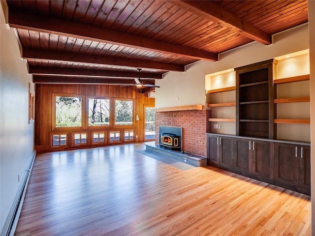 unfurnished living room with a baseboard heating unit, a wood stove, light hardwood / wood-style floors, wooden ceiling, and beam ceiling