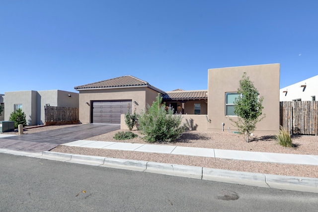 pueblo-style house featuring a garage