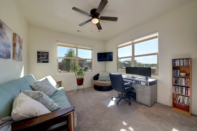 office with light colored carpet and ceiling fan