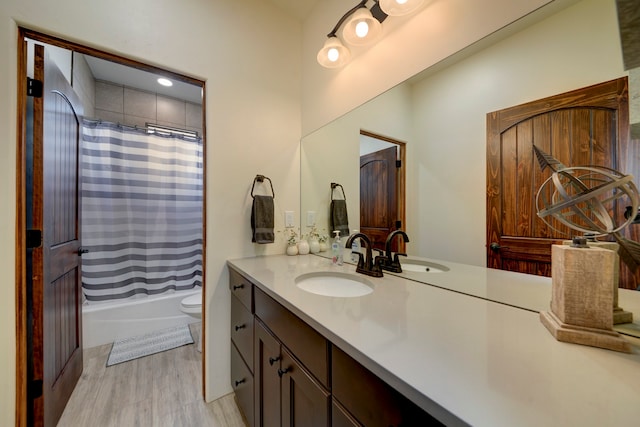 full bathroom featuring vanity, shower / bath combo, wood-type flooring, and toilet